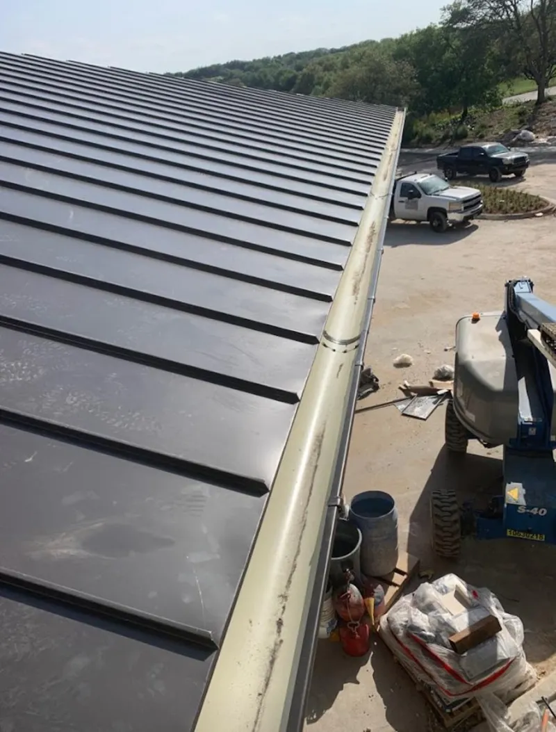 Standing seam panel and gutter detail on a metal roofing jobsite in Round Lake Park